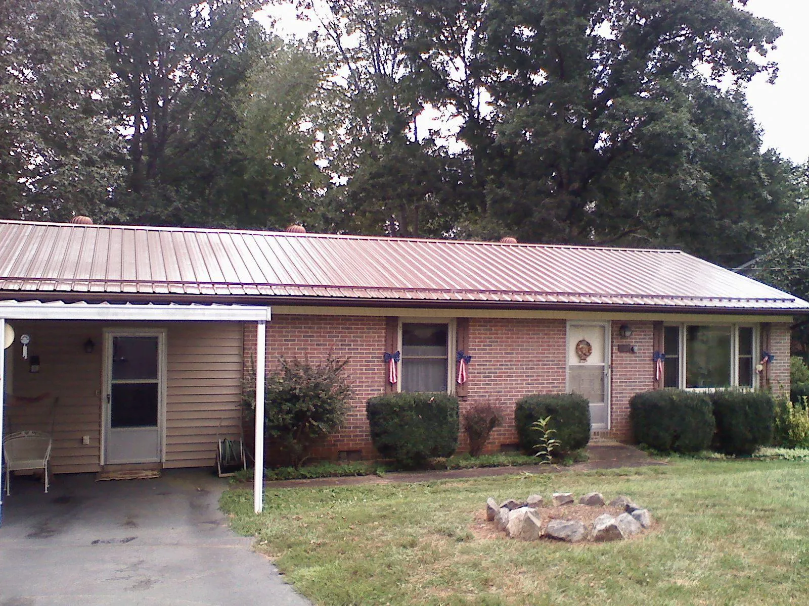 Bronze metal roof and carport on a brick ranch home — Roof Repair work by our crew in Snow Shoe